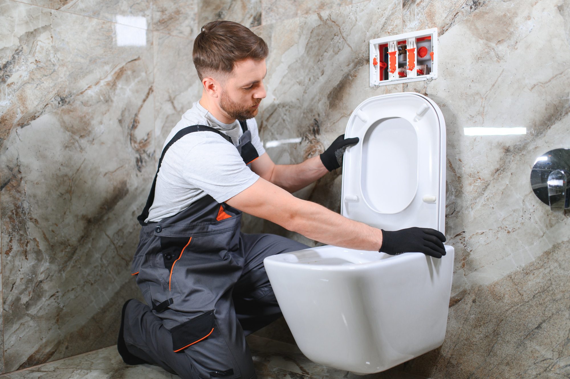 plumber-installing-toilet-in-restroom
